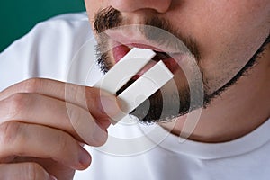 portrait of a young man eating chewing sticks