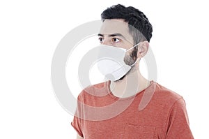 Portrait of young man with face mask looking side on copy space. 2019-nCoV.