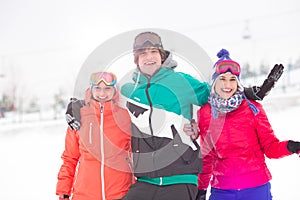 Portrait of young man with female friends enjoying in snow