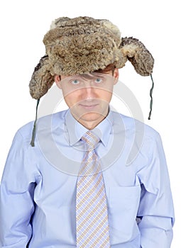 Portrait of young man in fur hat isolated on white