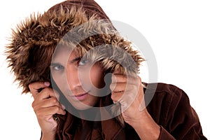 Portrait of a young man with a furry hood