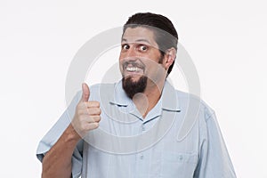 Portrait of a young man gesturing thumbs up against white