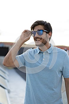 Portrait of a young man with glasses A sunlit day frames the confident gaze of a stylish young man, capturing his youthful charm