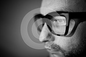 Portrait of young man in glasses working at PC. photo