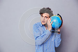 Portrait of a young man with globe