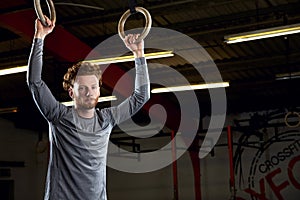 Portrait Of Young Man In Gym With Olympic Rings