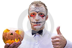 Portrait of young man on Halloween with burning pumpkin in hand isolated on white background. Bloody Halloween theme: