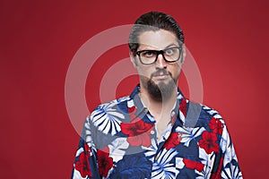 Portrait of a young man in Hawaiian shirt with raised eyebrow