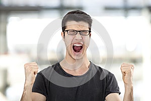 Portrait of a young man with her fist raised