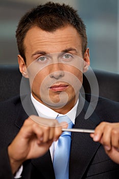 Portrait of young man holding pen