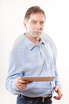 Portrait of young man holding tablet