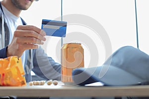 Portrait of a young man holds and using credit card for game money top up