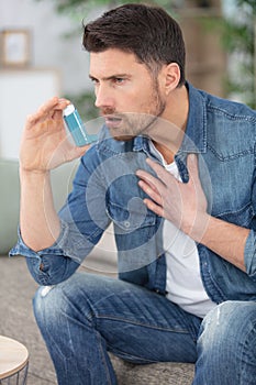 portrait young man inhaling through inhaler