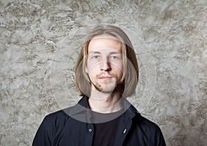 Portrait of young man with long blond hair