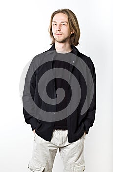 Portrait of young man with long blond hair, black shirt, white b