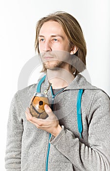 Portrait of young man with long blond hair on a white background