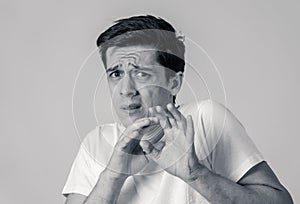 Portrait of a young man looking scared and shocked. Human expressions and emotions