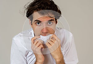 Portrait of a young man looking scared and shocked. Human expressions and emotions