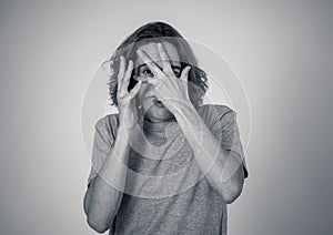 Portrait of a young man looking scared and shocked. Human expressions and emotions