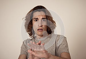 Portrait of a young man looking scared and shocked. Human expressions and emotions