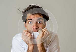 Portrait of a young man looking scared and shocked. Human expressions and emotions