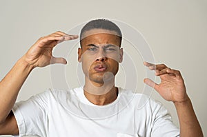 Portrait of a young man looking scared and shocked at something. Human expressions and emotions