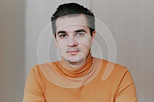 Portrait of a young man. The man looks at the camera