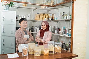 Portrait young man and muslim woman selling packaged products