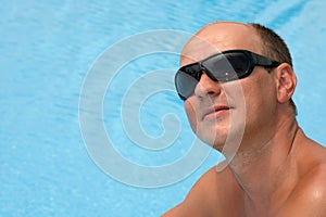 Portrait of a young man near the swimming pool