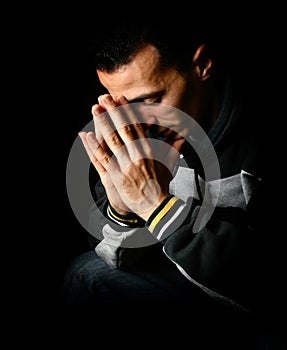 Portrait of young man with palms together