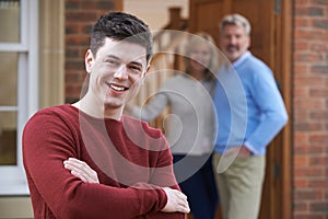 Portrait Of Young Man With Parents At Home photo