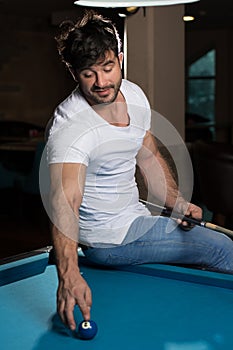 Portrait Of A Young Man Playing Billiards