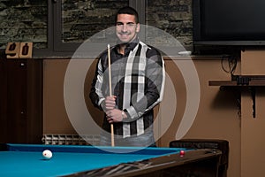 Portrait Of A Young Man Playing Billiards