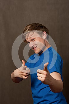 Portrait of a young man in pointing at camera
