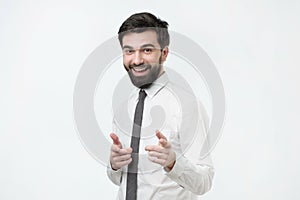 Portrait of a young man pointing his finger at you