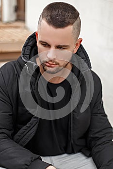 Portrait of a young man with a short hair in a warm winter