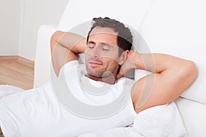 Portrait Of Young Man Sleeping On Bed