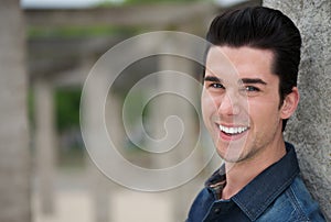 Portrait of a young man smiling outdoors