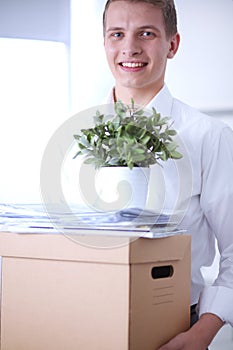 Portrait of young man smiling sitting on gray background. Portrait of young man