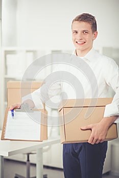 Portrait of young man smiling sitting on gray background. Portrait of young man