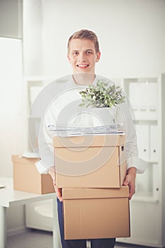 Portrait of young man smiling sitting on gray background. Portrait of young man