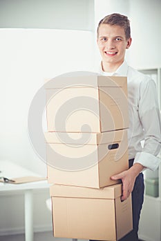 Portrait of young man smiling sitting on gray background. Portrait of young man