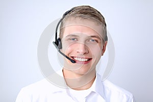 Portrait of young man smiling sitting on gray background. Portrait of young man