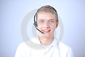 Portrait of young man smiling sitting on gray background. Portrait of young man