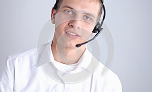 Portrait of young man smiling sitting on gray background. Portrait of young man