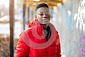 Portrait of a young man standing in a city street