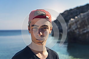 Young man standing in front of the ocean