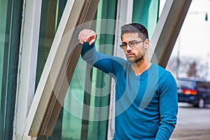 Portrait of young Man standing outdoors, relaxing, thinking