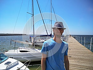 Portrait of a young man standing on the pier