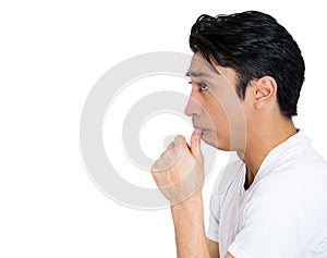 portrait young man, student with finger in mouth, sucking thumb, biting fingernail in stress, deep thought, confused, isolated on